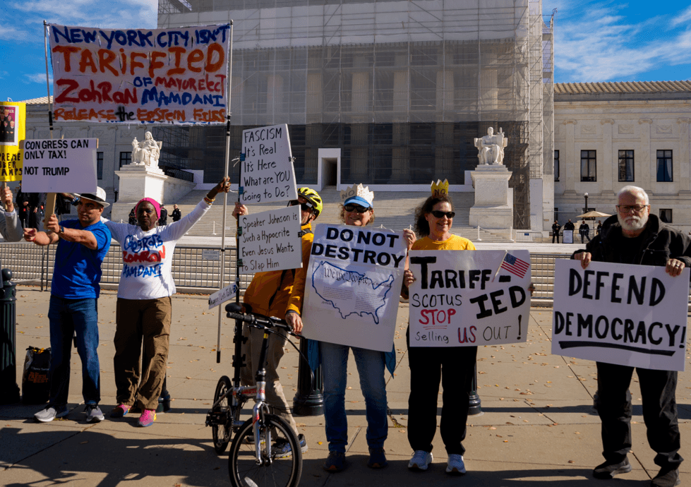 Activists pose for photographs outside the Supreme Court on November 5