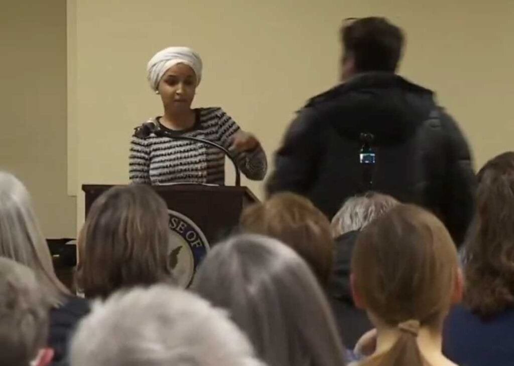 Man Rushes Ilhan Omar at Minneapolis Town Hall, Sprays Her With Liquid Before Being Tackled by Security